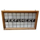 A 20th century leaded stained glass advertising panel 'Perfumery' set in pine frame, 60 x 113cm.