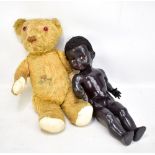 A vintage golden mohair teddy bear with amber glass eyes, length 43cm, and a Pedigree doll (both af)