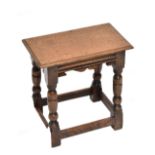 A good quality reproduction oak joint stool on stretchered block supports, height 44.5cm, length