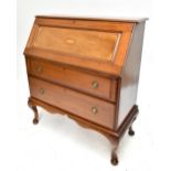An Edwardian mahogany and inlaid bureau, the fall front enclosing fitted interior above two long