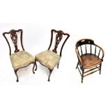 A pair of Edwardian mahogany Chippendale style bedroom chairs with foliate carved backs and floral