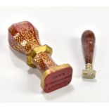 A Victorian red Lithyalin gilt glass hand seal with gilt scrolling decoration, inscribed Pishiobury,