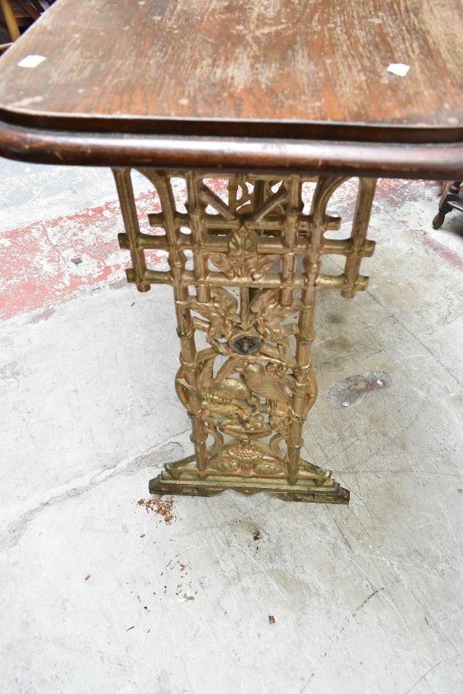 A Victorian cast iron framed table with later oak top, the base with pierced floral detail, height - Image 3 of 4