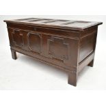 An 18th century oak coffer with panelled decoration and raised on block supports, height 59.5cm,