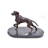 An early 20th century bronze figure of a pointer raised on an oval black marble base, bearing