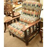 An Arts & Crafts oak framed reclining chair with Liberty fabric upholstery on stretchered supports.
