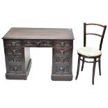 A Victorian carved oak Flemish style kneehole desk with carved detail to the drawer fronts, height