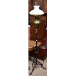 A Victorian wrought iron adjustable oil lamp on stand with detachable brass Messenger's patent