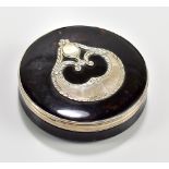 A Regency tortoiseshell table snuff box of circular form with white metal banding and central mount,