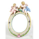 MEISSEN; a late 19th/early 20th century girondelle easel back mirror with applied decoration