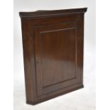 A 19th century oak flat fronted hanging corner cupboard, height 88cm, width 65cm, depth 44.5cm.