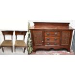 A circa 1900 mahogany sideboard with three central drawers, flanked by two carved, panel cupboard