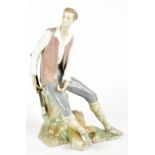 LLADRO; a figurine depicting a seated lumberjack holding a pipe, height 37cm, printed factory