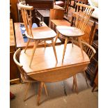 ERCOL; an elm drop leaf table on splayed supports, approx 72 x 112 x 120cm when extended, and a