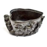 A 20th century Chinese carved black soapstone brush washer featuring monkey, flowering prunus and