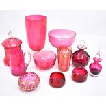 A small group of cranberry glass including vase, lidded scent bottles, bowls etc, two with gilt