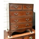 A reproduction mahogany and inlaid narrow chest of two short over three long drawers, raised on