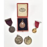 FATTORINI & SONS; a bronzed shooting medal, embossed with rifles and vacant cartouche, diameter 3cm,