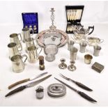 A mixed group of electroplated and pewter items including mugs, candlestick, salver, etc.