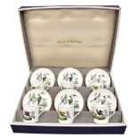 ROYAL WORCESTER; six coffee cans and saucers each decorated with exotic birds in landscape scenes