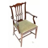 An Edwardian mahogany framed Chippendale-style mid-sized armchair with carved detail and green