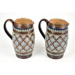 DOULTON LAMBETH; a pair of stoneware jugs of barrel form each having tube line decoration with a