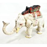 An early/mid-20th century cast iron money bank modelled as an Indian elephant with painted detail,