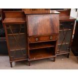 An Edwardian mahogany and inlaid side by side bureau bookcase, the central fall front enclosing