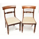 A pair of early 19th century mahogany bar back dining chairs with upholstered seats on fluted