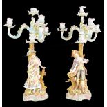 A pair of 19th century Continental porcelain candelabra, modelled in the form of a gentleman and a