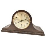 An early 20th century oak case eight day mantel clock, the circular silver dial set with Arabic