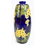 MINTON LTD; a Secessionist range vase with tubeline decoration of floral sprays on a cobalt blue