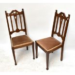 A set of four early 20th century oak Liberty-style hall chairs with carved detail and velvet