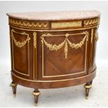 A reproduction Empire style demi-lune shaped sideboard with applied gilt metal detail, the central