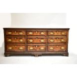 An 18th century oak dresser with an arrangement of nine drawers raised on bracket feet, height 94cm,