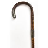 A late 19th/early 20th century sectional bamboo cane with hallmarked silver finial and collar, the