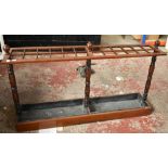 A late Victorian mahogany twenty four division rectangular stick stand with two drip trays, height