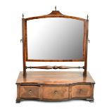 An Edwardian mahogany inlaid toilet swing mirror with brass finials and bevelled glass above three