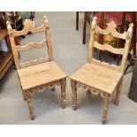 A pair of late Victorian pine Gothic Revival side chairs with carved detail on turned front supports