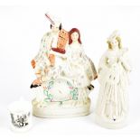 Two 19th century Staffordshire flat back figurines including a gentleman sitting beside a lady above