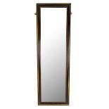 A rectangular ebonised and gilt detailed wall mirror with bevelled glass, 132 x 42cm.Additional