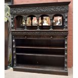 A 19th century Flemish style carved oak sideboard with foliate carved frieze above four arches and