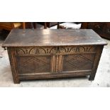 An 18th century carved oak coffer with carved panelled detail, height 55cm, length 112cm, depth