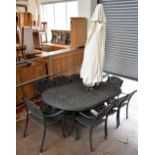 A good quality modern cast metal garden table and eight armchairs, with central parasol, height