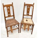 A pair of Arts & Crafts oak framed hall chairs with pierced detail on tapered front stretchered
