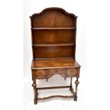 An early 20th century reproduction William and Mary style walnut dresser with arched top and two