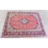 A good quality Eastern style rug with stylised symbols and floral decoration, 335 x 258cm.Additional