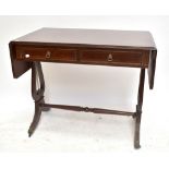 A reproduction mahogany veneered sofa table, with two drawers raised on lyre supports, height