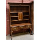 An early 20th century oak dresser, the plate rack back with three shelves and single crossbanded