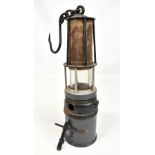 FRIEMANN & WOLF; a tall miner's flame safety lamp with key and hanging hook, height approx 34cm